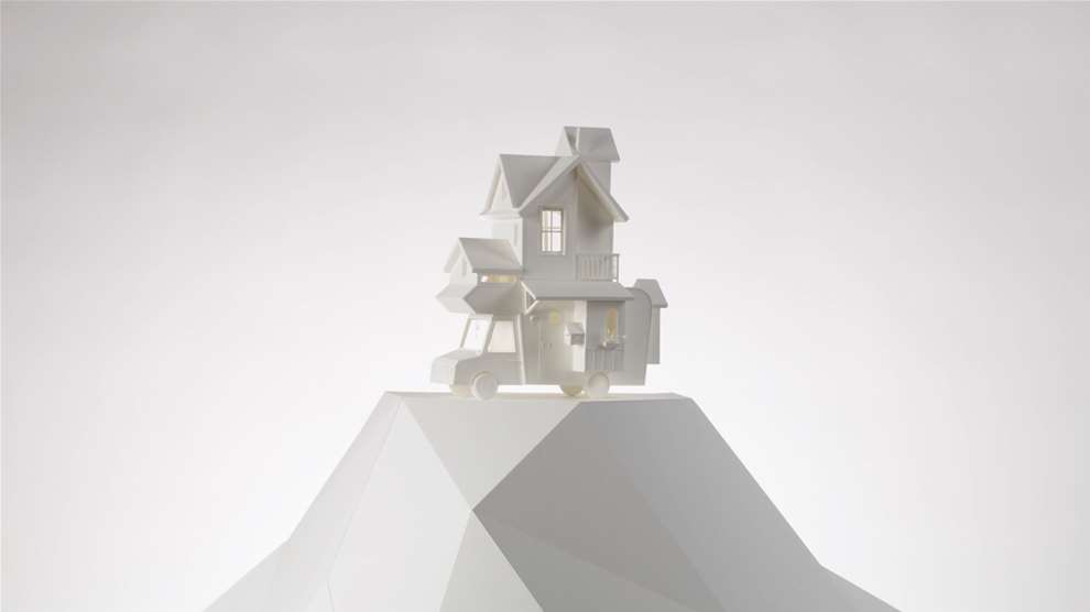 Vera Van Wolferen, Crafted intricate paper sculpture of a magical house with a book on its roof.